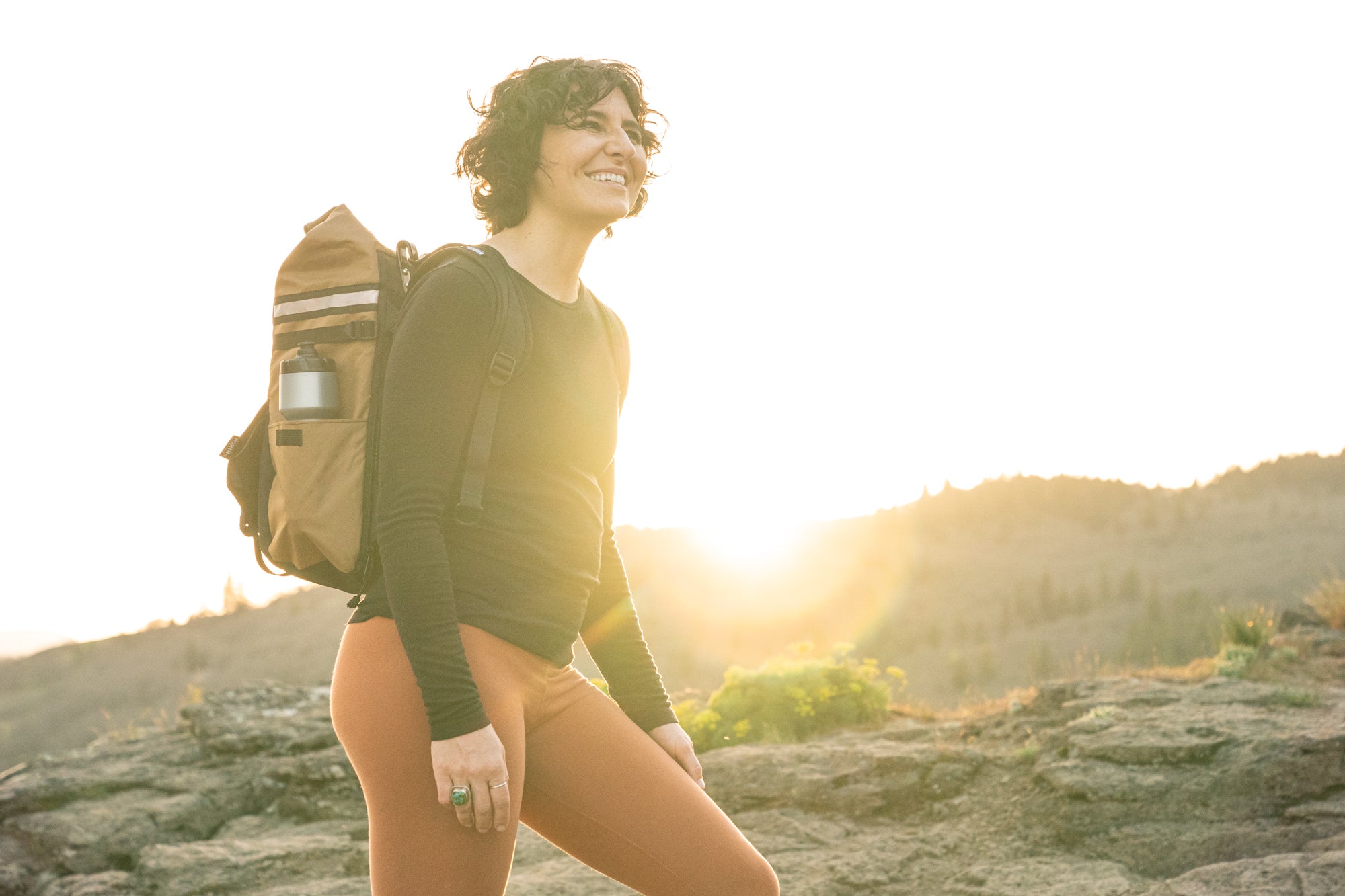 woman wearing backpack on a mountain trail