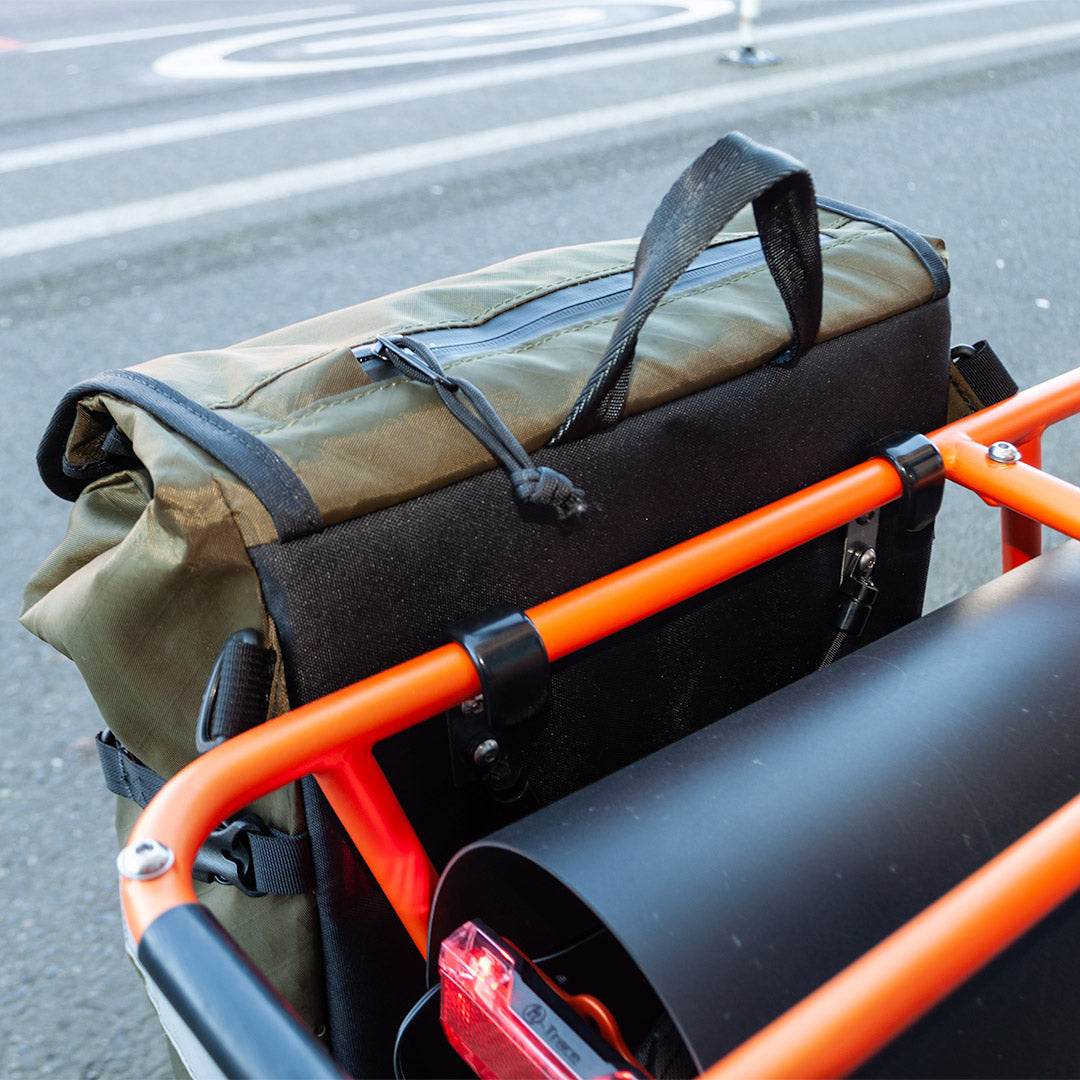 Pannier attached to cargo bike with oversized hooks.