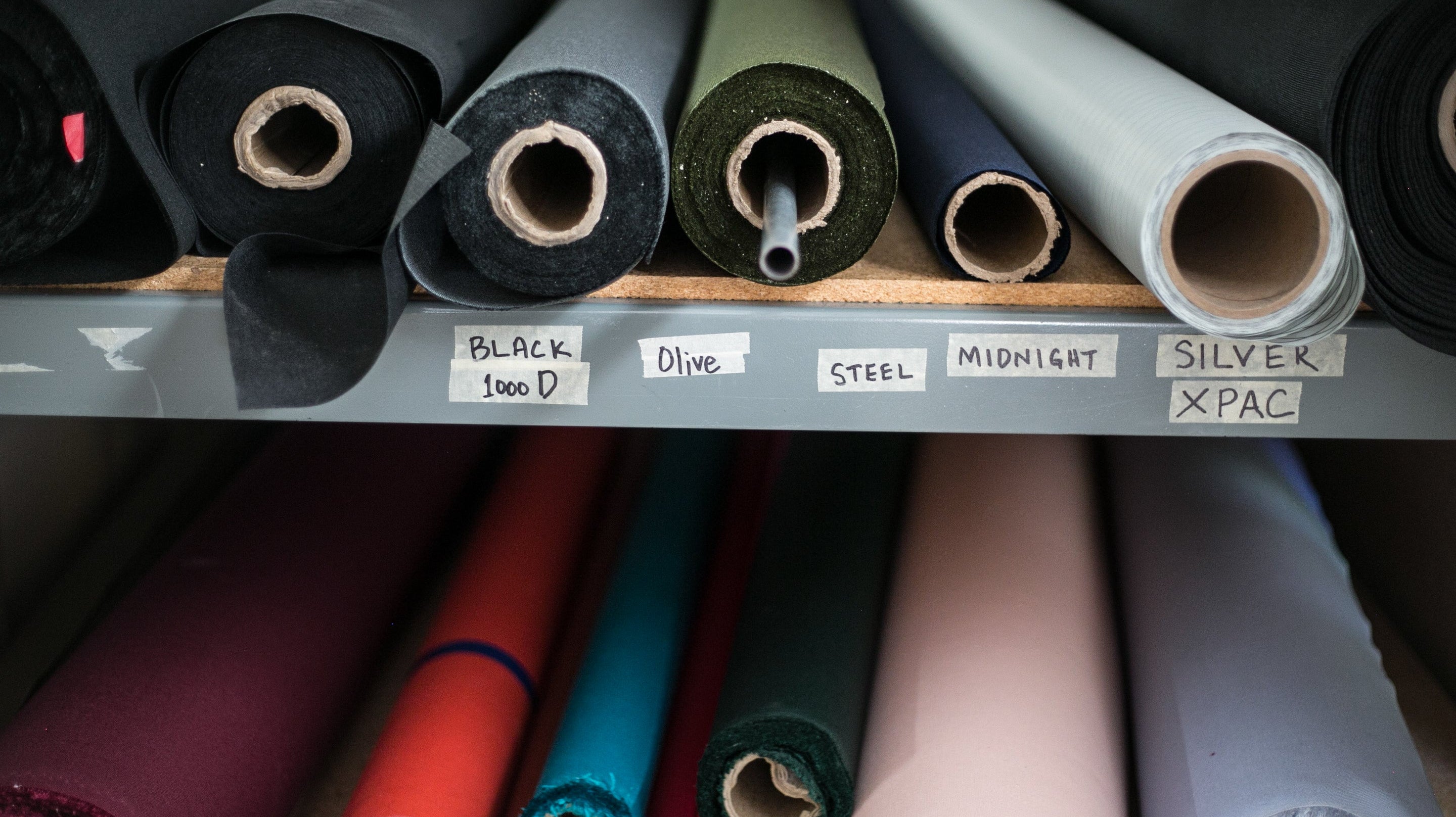 rolls of fabric on a warehouse shelf
