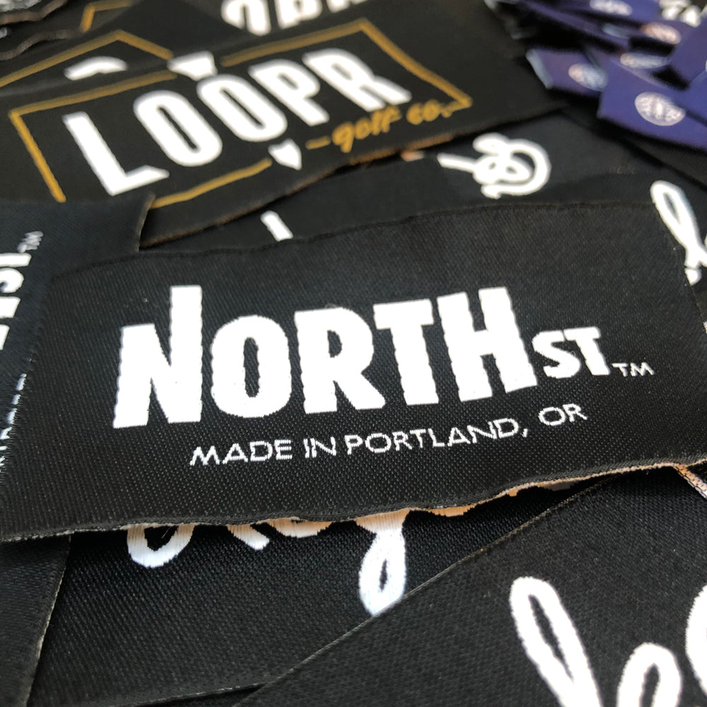 pile of woven labels with different brands