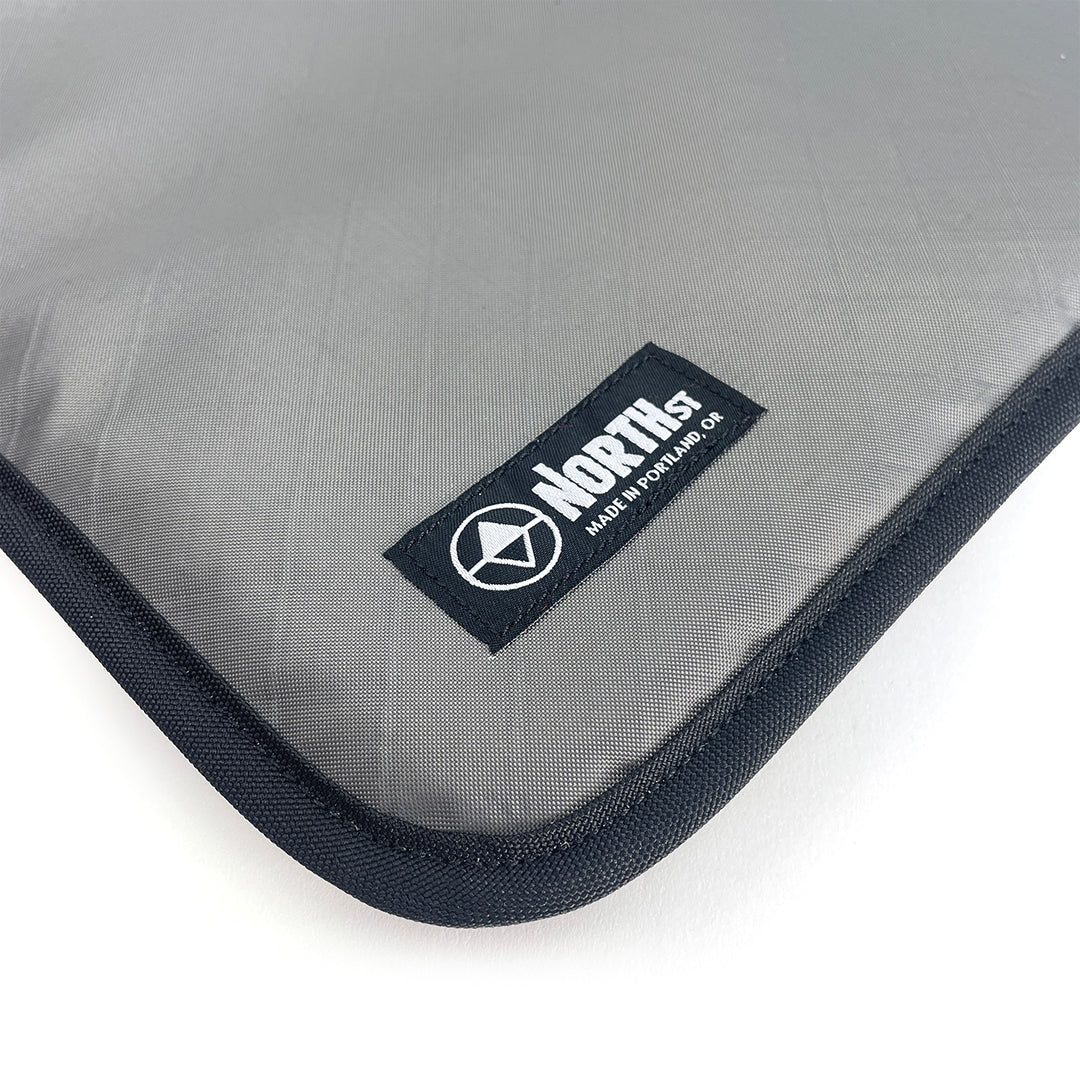 Gray laptop sleeve with North St Label visible