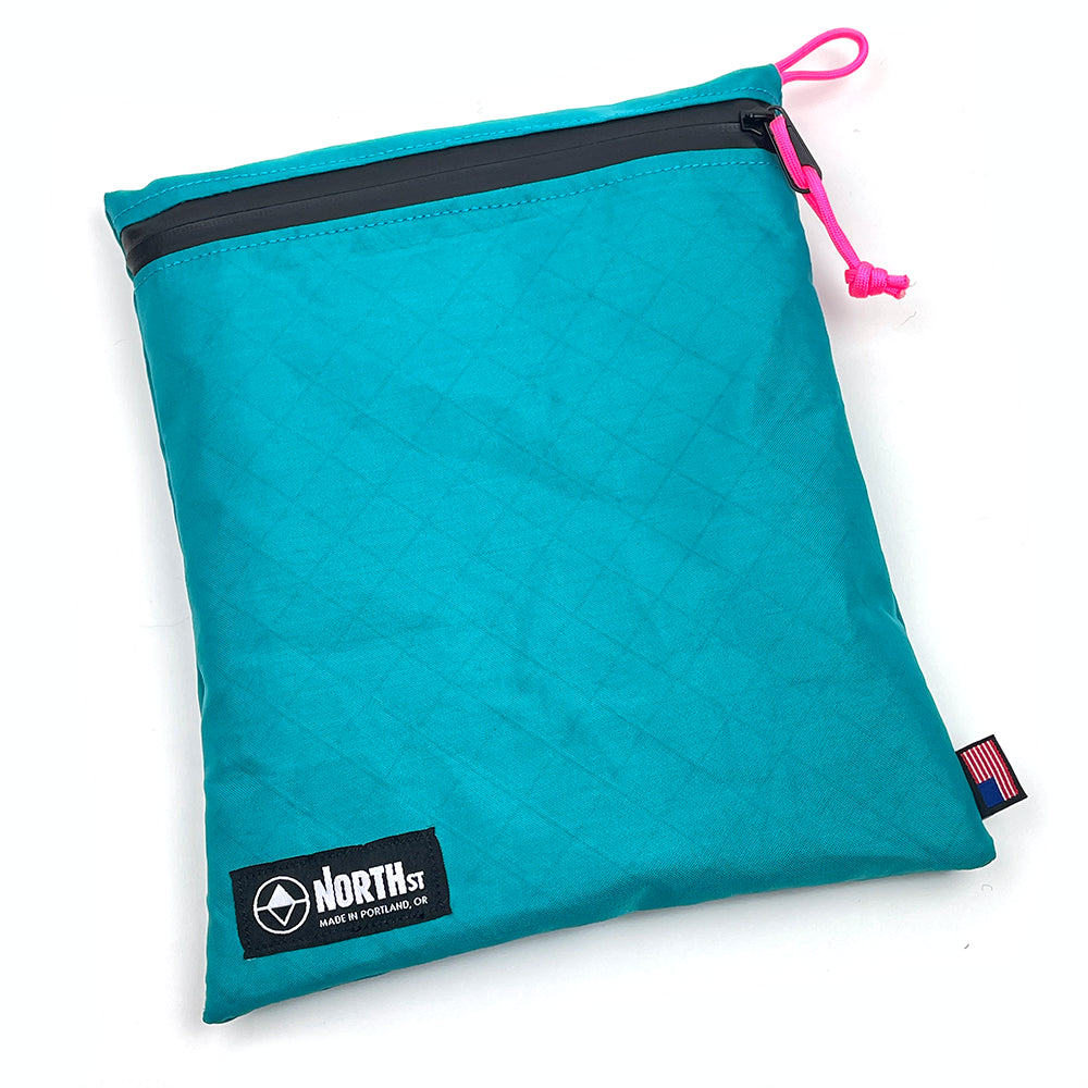 Large teal pouch with zipper and visible brand logo