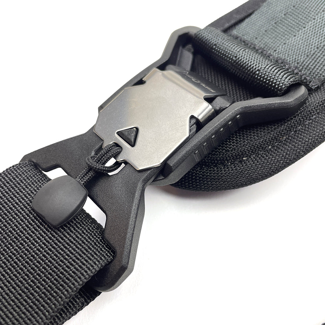 Close-up of a black belt with a metal buckle on a white background
