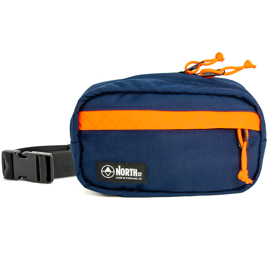 Blue and Orange waist bag with a visible brand logo on a white background. Pioneer 9 by North St Bags