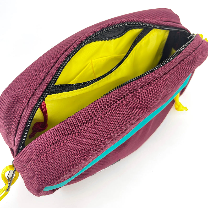 Burgundy bag with yellow interior on a white background