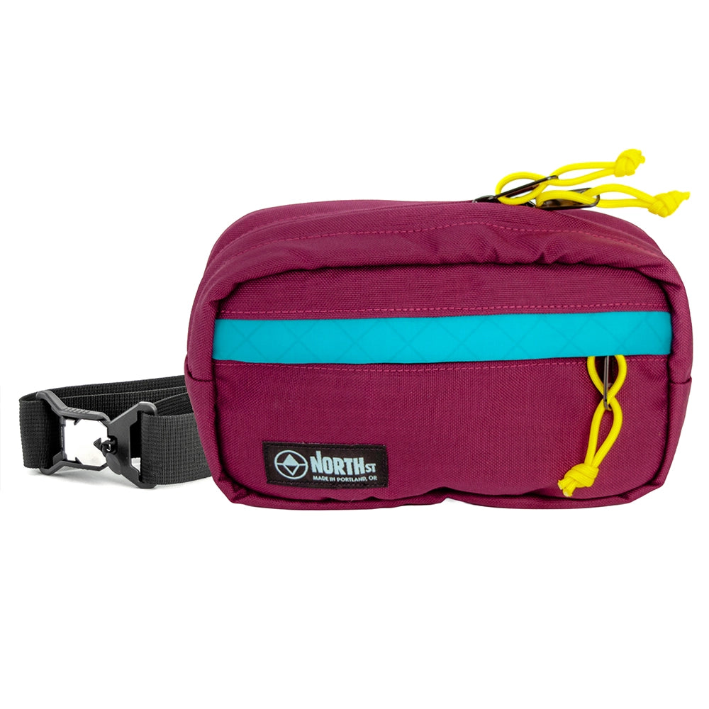 pioneer 9 hip pack in burgundy with teal accent and north st label