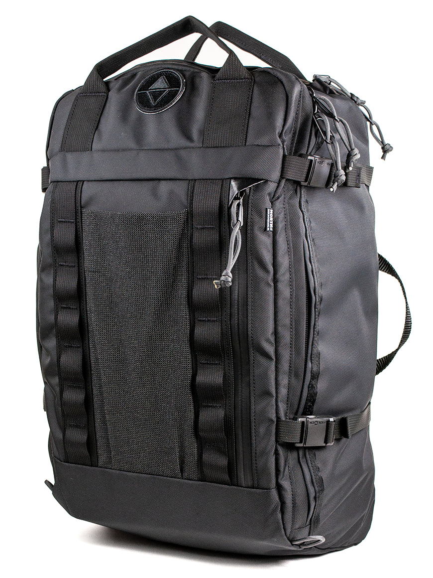 A black travel backpack with multiple zippered compartments, compression straps, and a top carry handle, shown on a plain white background.