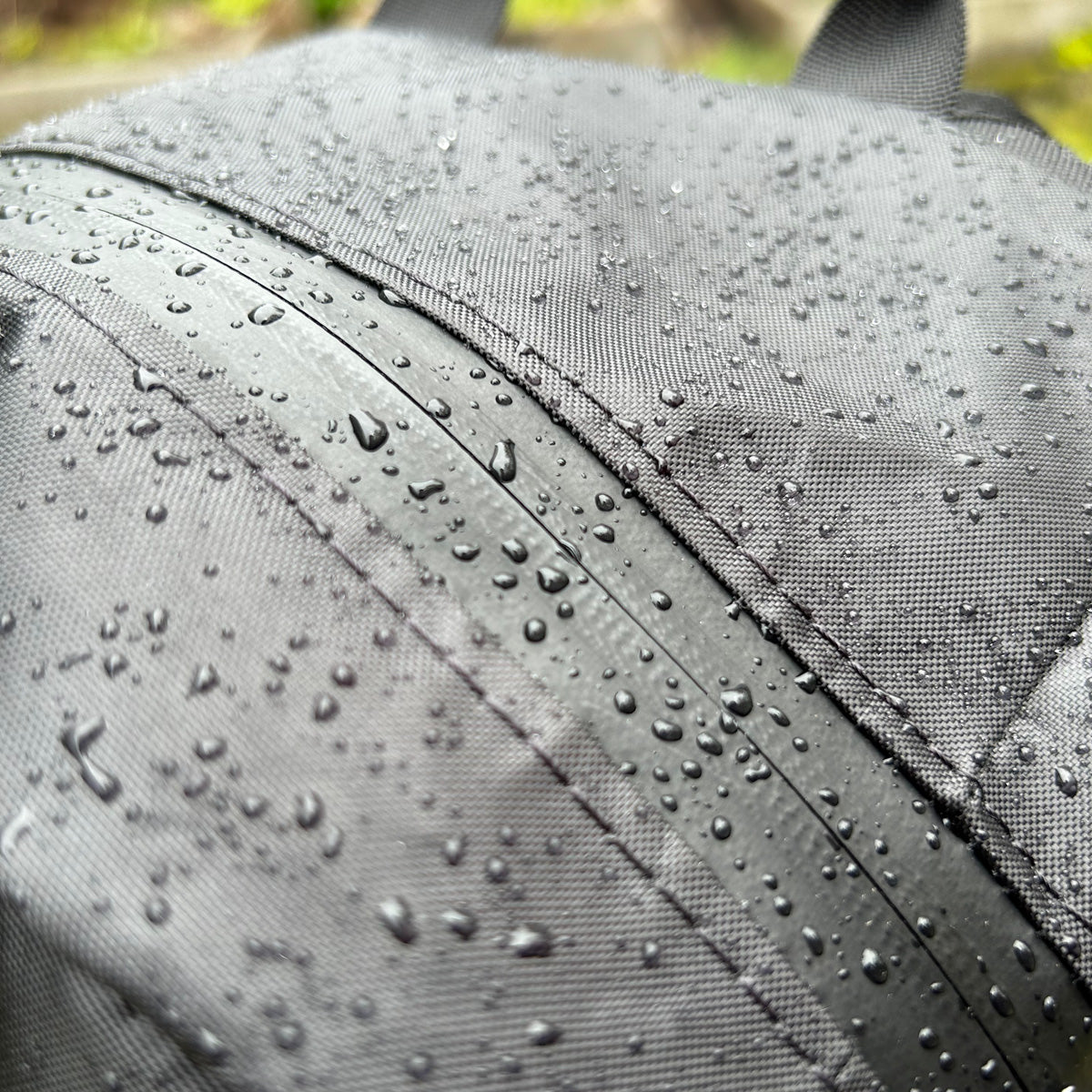 Closeup shot of fabric and zipper with water dropsVancouver Daypack - North St. Bags all-groups
