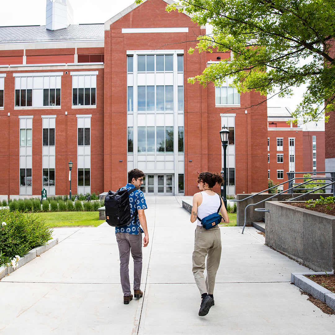 couple walking along path at a college campus