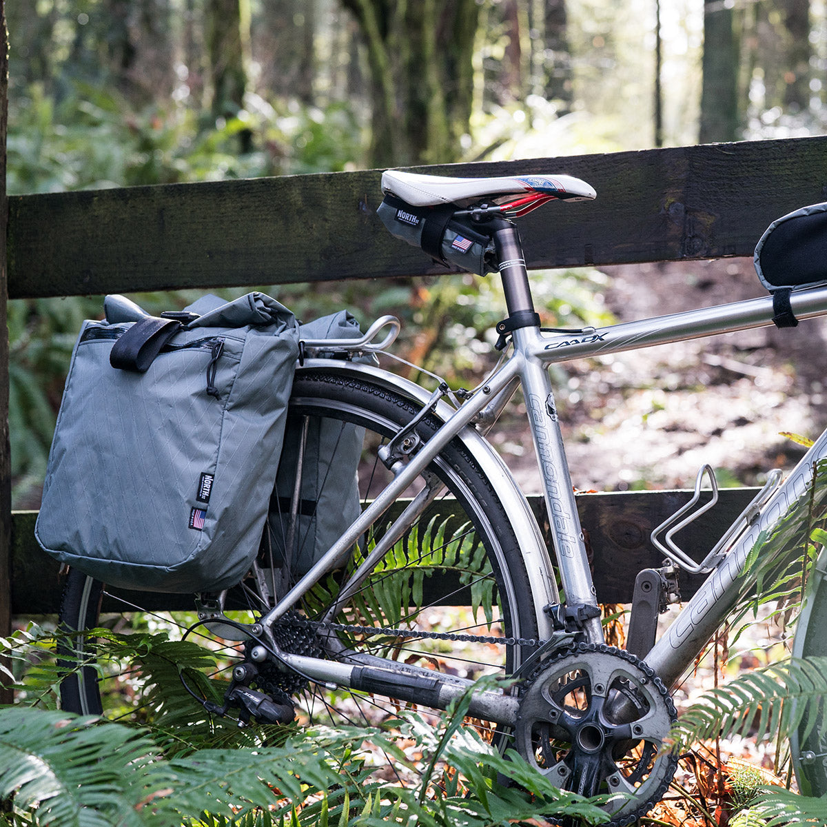 gravel bike with panniers in the woods