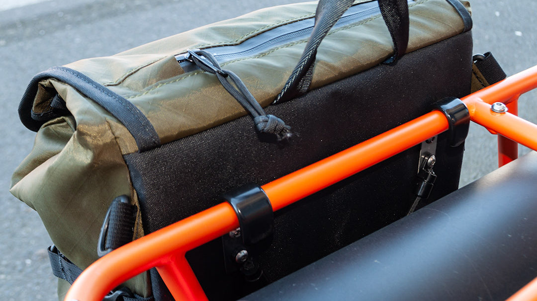Pannier attached to cargo bike with oversized hooks.
