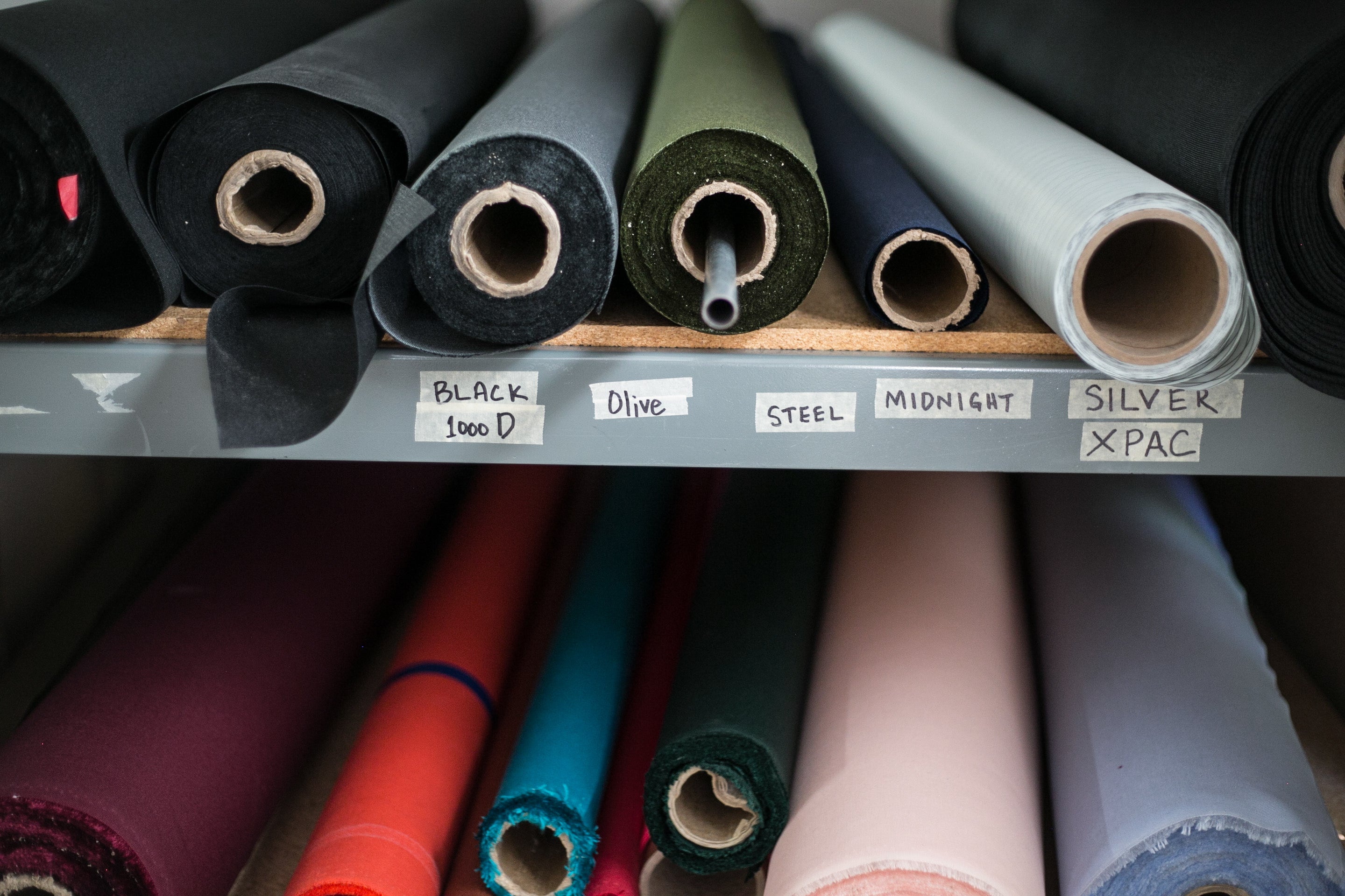 rolls of fabric on a warehouse shelf
