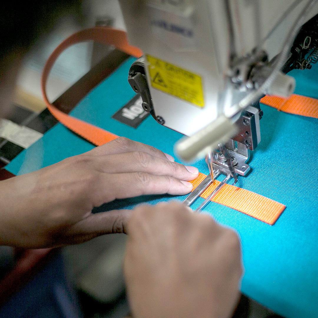 hands using a sewing machine making a north st bag