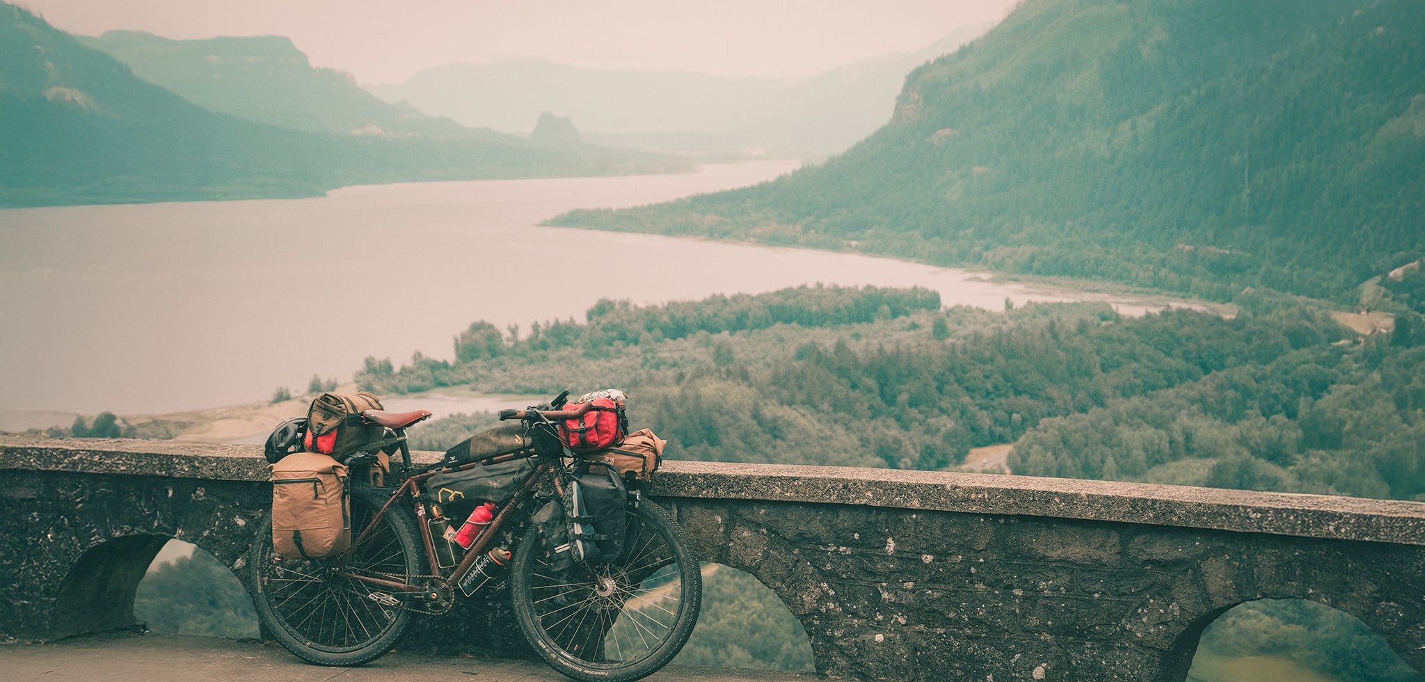 bike leaning against a stone wall at a vista