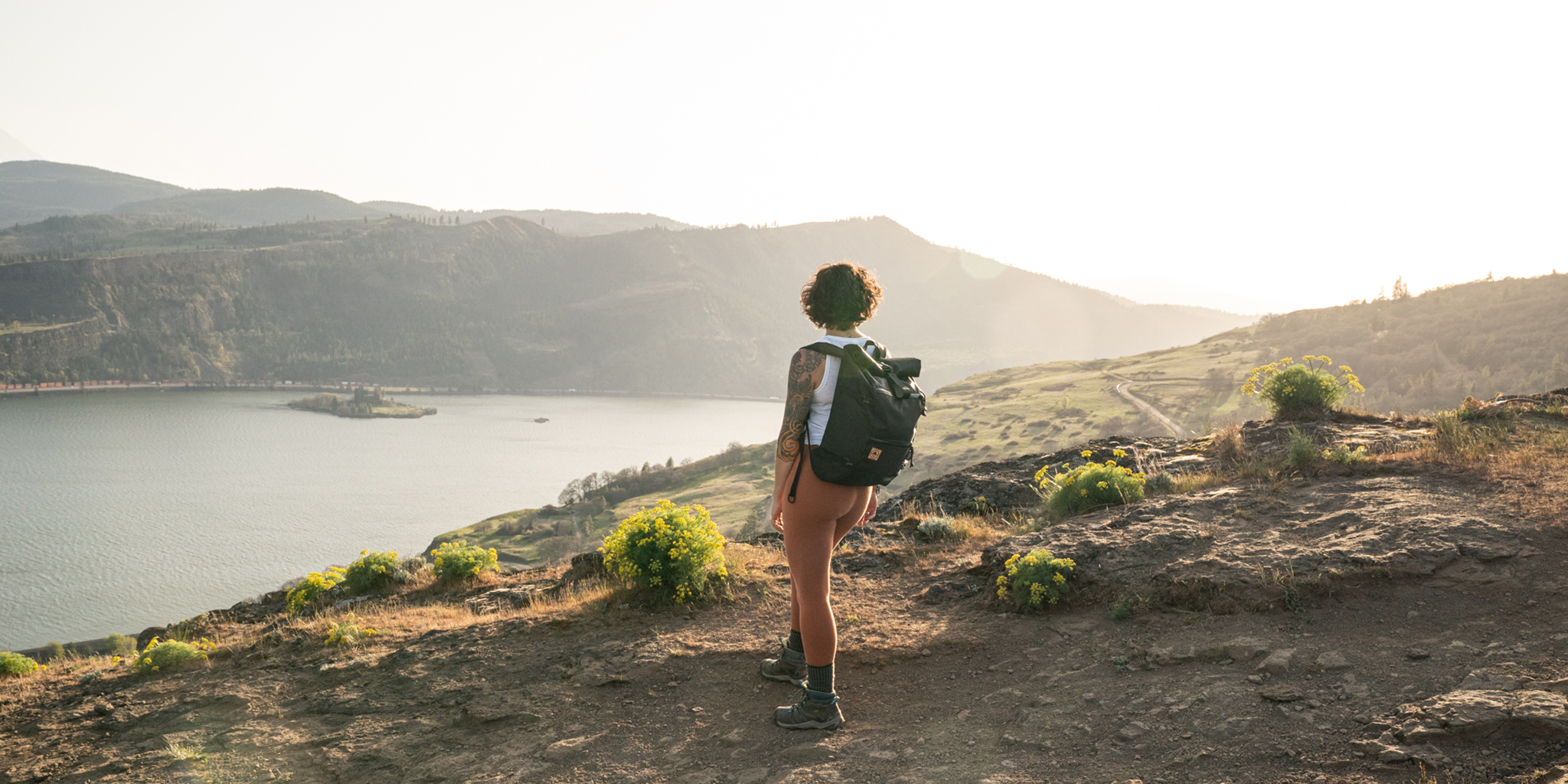 Woman wearing backpack on a hike in the Columbia River Gorge. | North St Bags