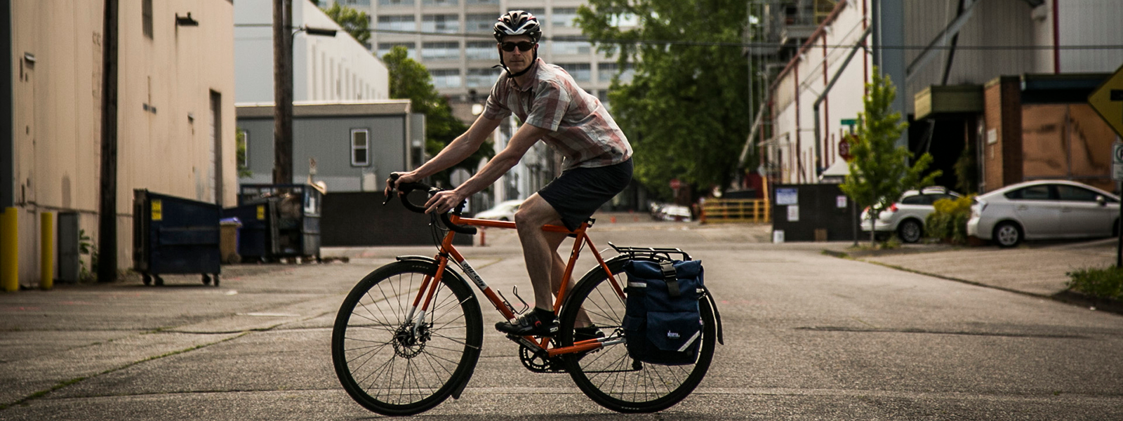 Man on bicycle on a Portland street with Backpack Pannier | North St Bags