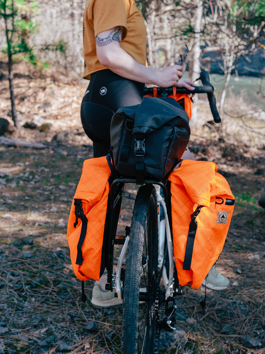 Cyclist on a forest trail with bikepacking bags. - North St Bags all-groups