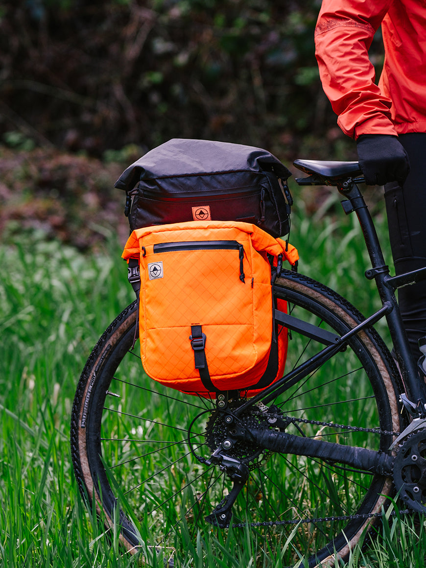 Gravel bike in the woods with Roll-Top Trunk Bag and panniers - North St. Bags all-groups