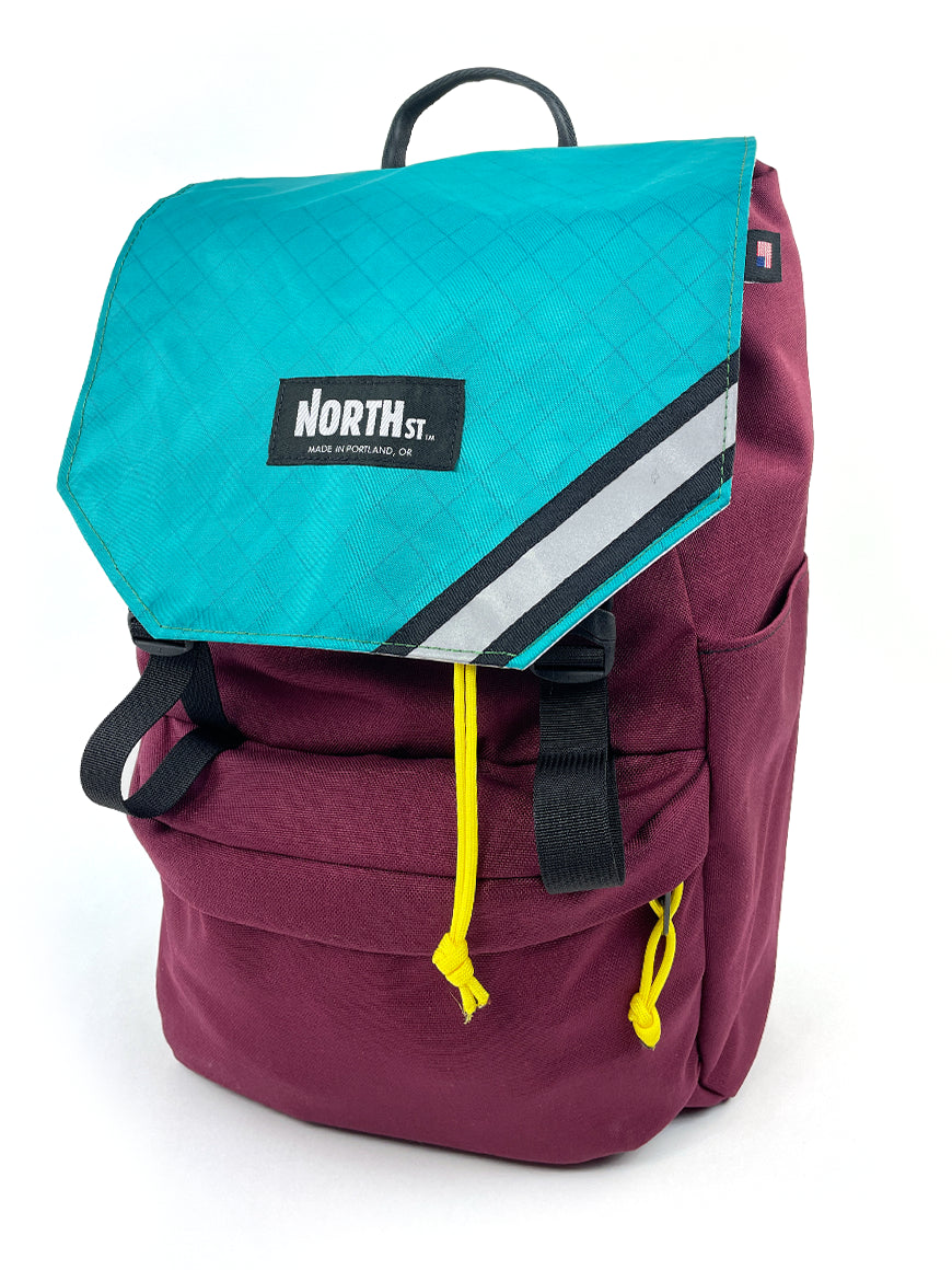 Front view of stylish backpack pannier in Burgundy and Teal.  Morrison Backpack Pannier 22L - North St. Bags
