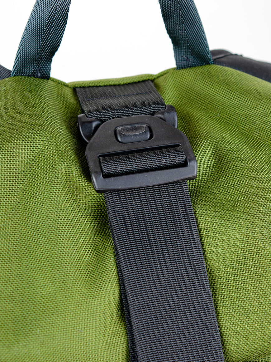 Green bag with a black strap and buckle on a white background all-groups
