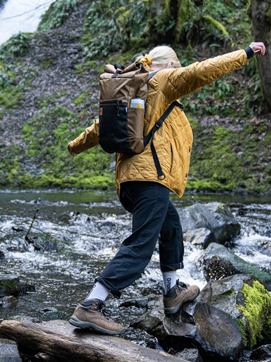 Woman hiker crossing a river on a waterfall trail. - Davis Daypack - North St Bags all-groups