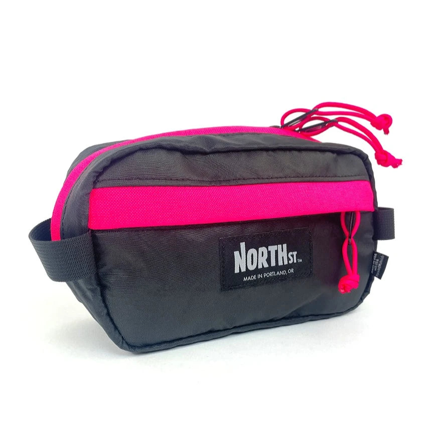 Front view of Pioneer 9 Hip Pack in black and hot pink. - North St. Bags
