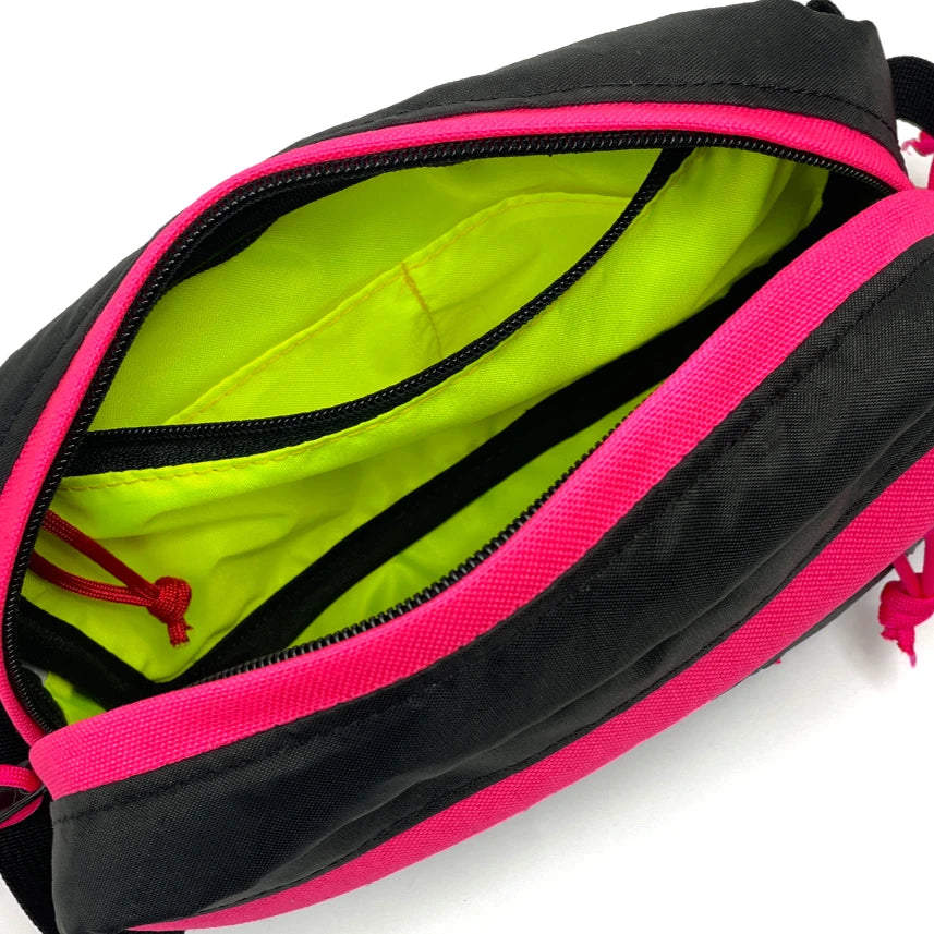 Interior view of Pioneer 9 Hip Pack in black and pink with yellow lining  - North St. Bags