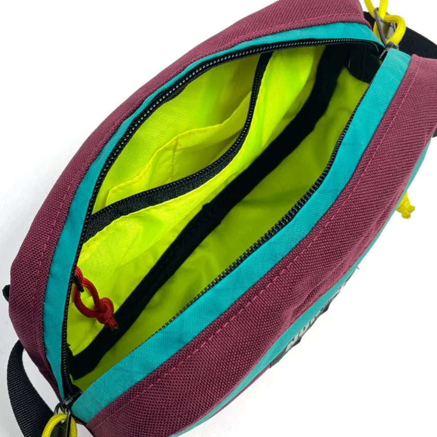 Interior view of Pioneer 9 Handlebar Pack in burgundy and teal  with yellow lining- North St. Bags