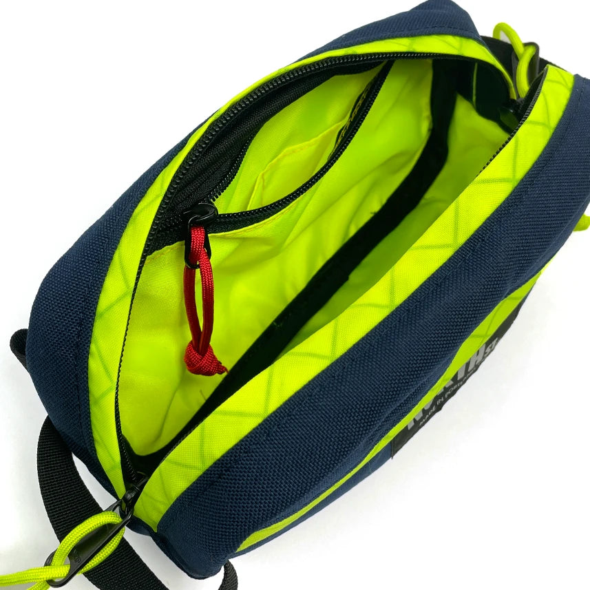 Interior view of Pioneer 9 Hip Pack in midnight and yellow. - North St. Bags