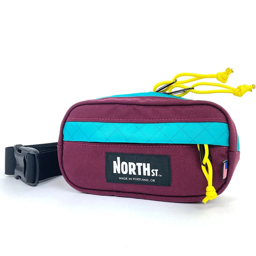 Front view of Pioneer 8 Hip Pack in Burgundy and Teal - North St. Bags