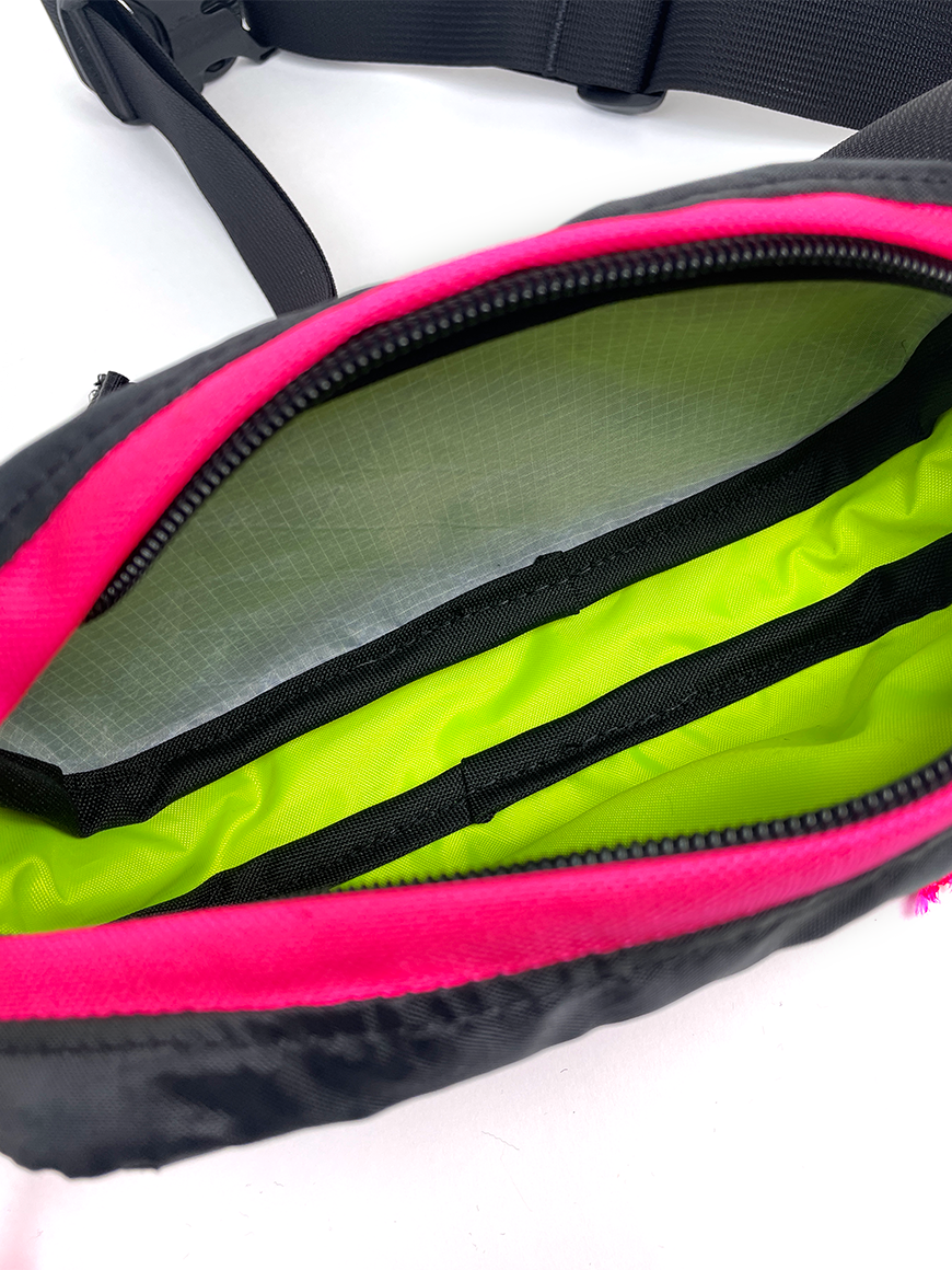 Interior view of Pioneer 8 Hip Pack in Black and Hot Pink with a yellow liner - North St. Bags