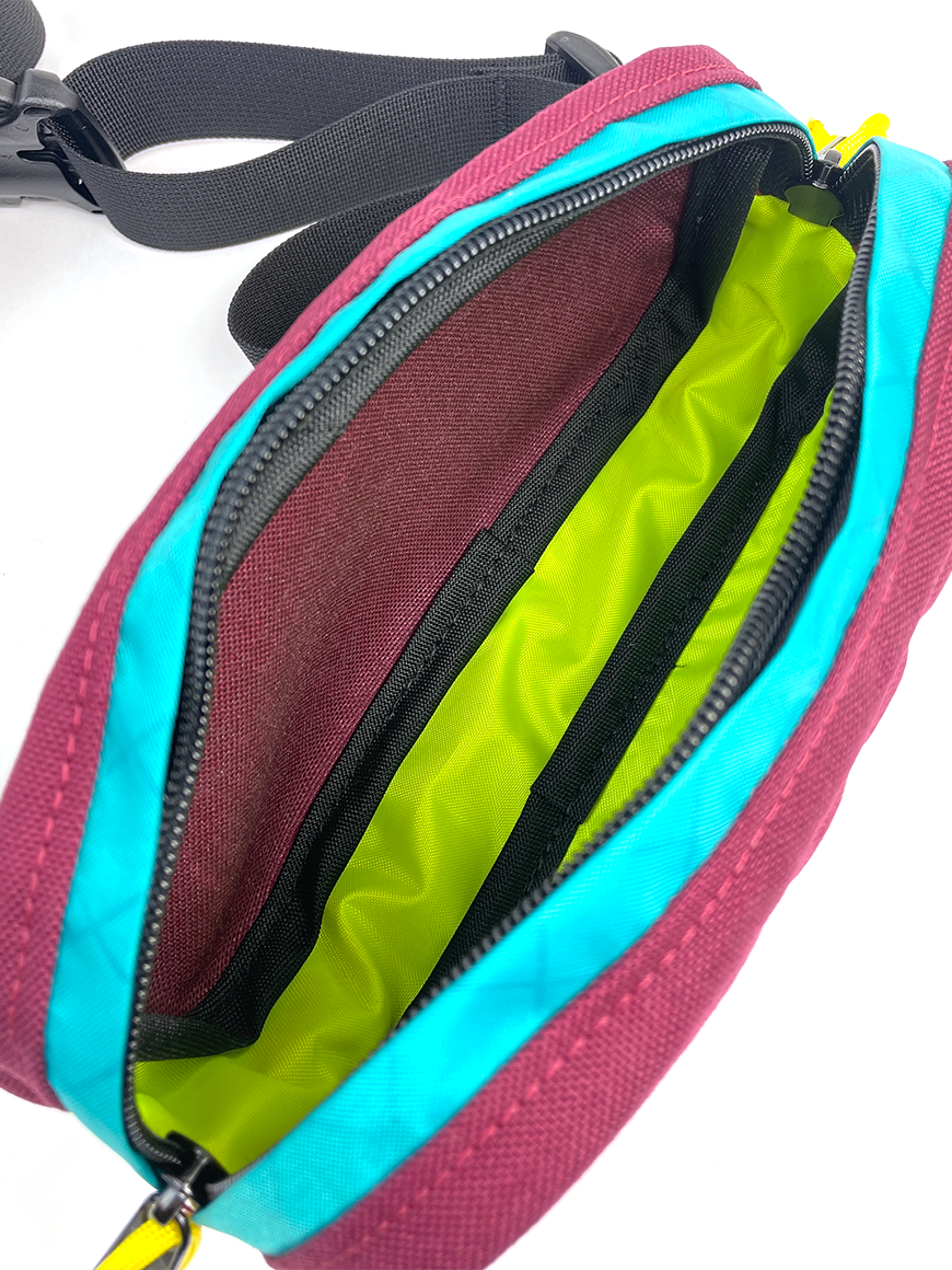 Interior view of Pioneer 8 Hip Pack in Burgundy and Teal with a yellow lining - North St. Bags