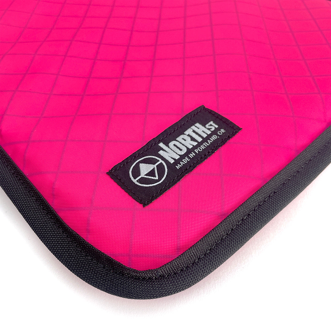 Pink laptop sleeve with North St Label visible