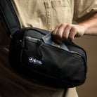 Close up view of man putting passport into a sling strap. all-groups