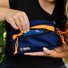 Person holding a blue and orange North Street sling outdoors. all-groups
