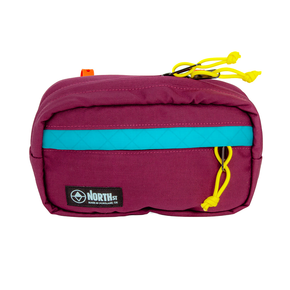 Front view of Pioneer 9 Handlebar Pack in Burgundy and Teal