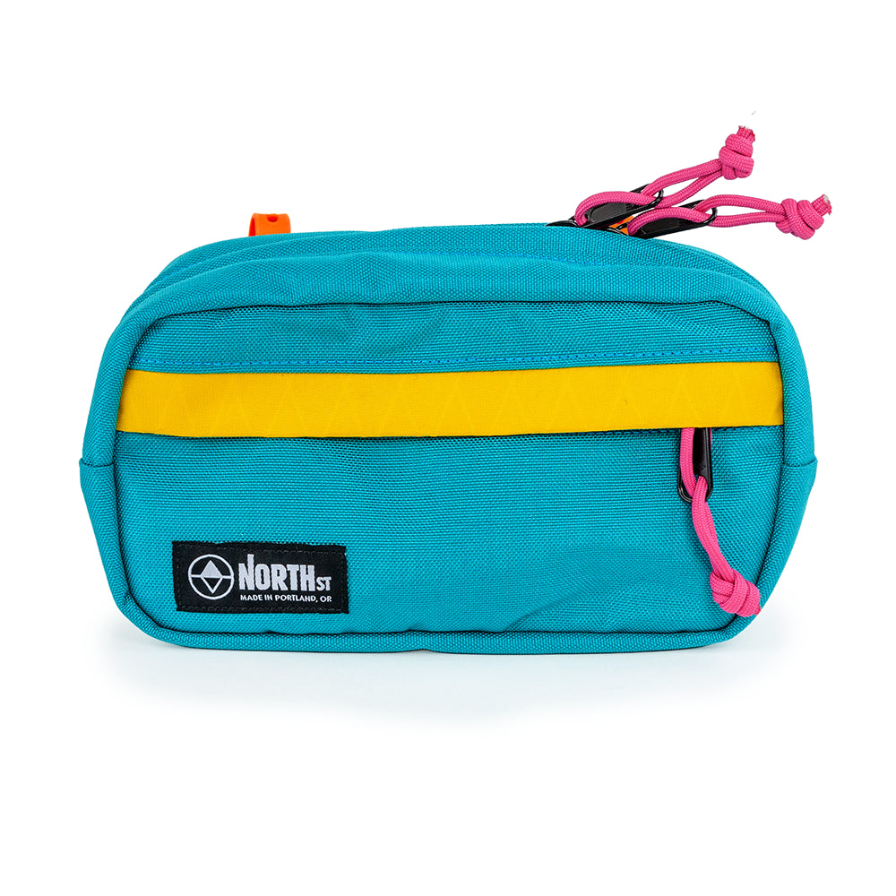 Front view of Pioneer 9 Handlebar Pack in Teal & Gold