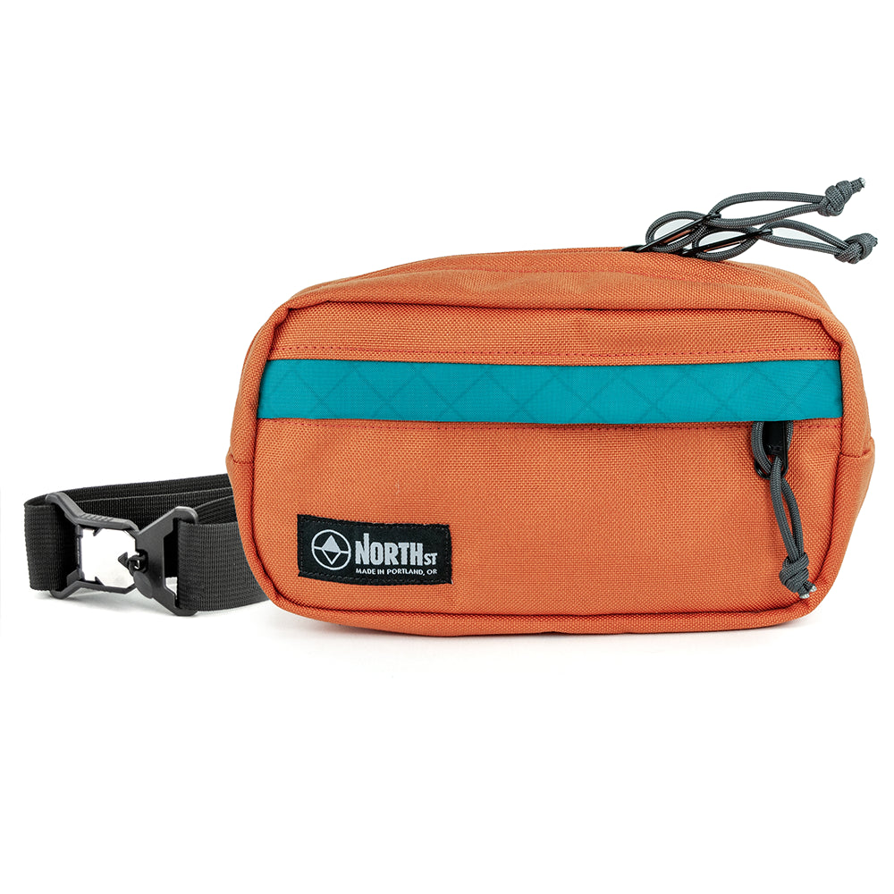 pioneer 9 hip pack in nurnt orange with a north st label on a white background