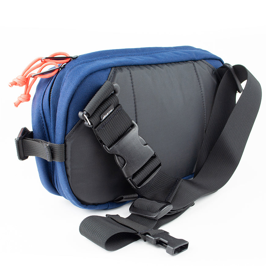 detail view of sling pack by North St showing back and strap