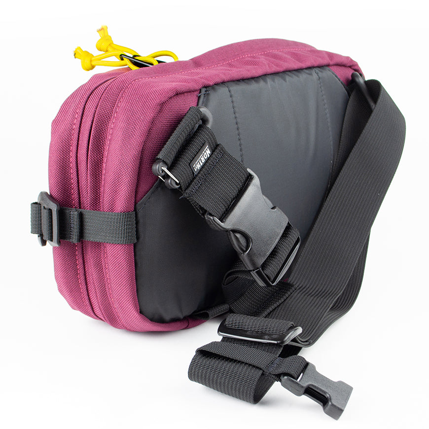 detail view of sling pack by North St showing back and strap