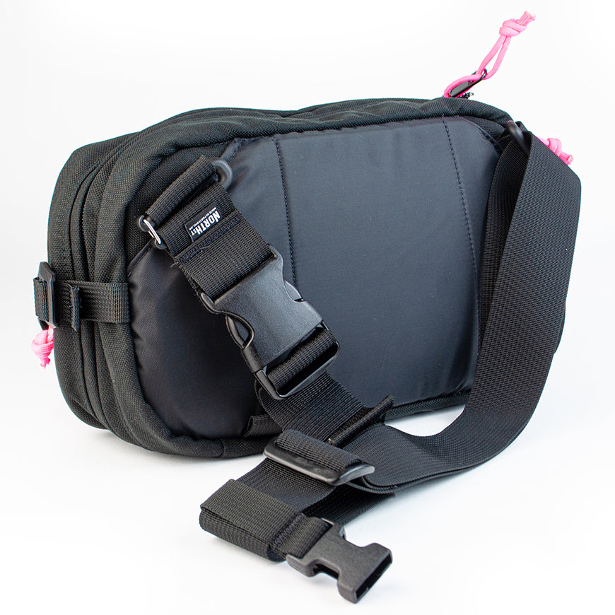 detail view of sling pack by North St showing back and strap