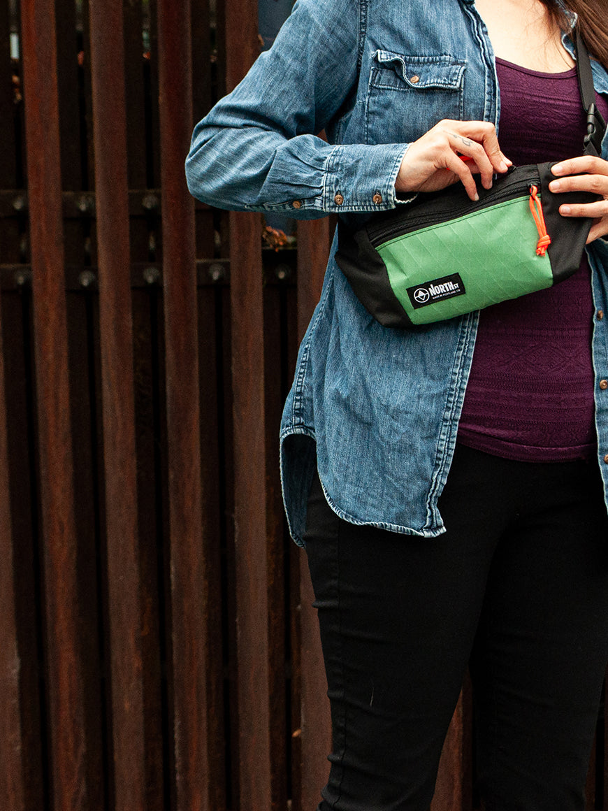 woman wearing a green sling pouch - North St Bags - all-groups