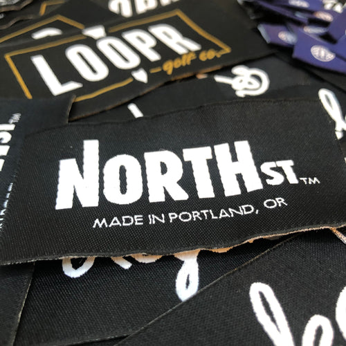 North St woven labels showing logo and "Made in Portland" tagline.