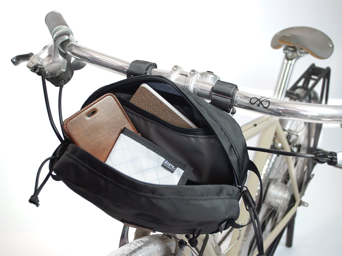 Interior view of Pioneer 9 Handlebar Pack mounted to bicycle. - North St. Bags all-groups