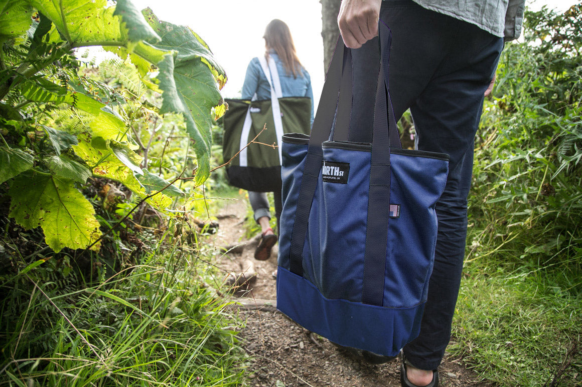 Couple hiking along a beach trail with tabor totes. - North St. Bags all-groups
